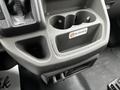 A grey cup holder with a no smoking sign in a 2021 Ford Transit interior