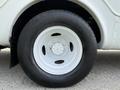 Close-up view of the white wheel and tire of a 2010 Ford Econoline showing the rim and tread details