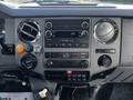 Dashboard of a 2011 Ford F-750 featuring a radio, climate control knobs, and various buttons and gauges