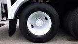 A close-up view of a white rim with tire mounted on a 2012 International 7400 truck