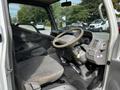 Interior of a 2004 Toyota Toyoace featuring a steering wheel dashboard gear shift and two front seats with fabric upholstery