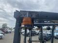 A 2010 Toyota 7FGGU25 forklift featuring an amber warning light mounted on the overhead guard