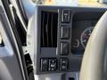 Close-up of the control panel in a 2016 Isuzu NRR featuring air vents and various buttons for vehicle functions