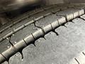 Close-up of a heavily worn tire tread from a 2018 Grande West Vicinity showing deep grooves and uneven wear patterns