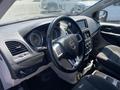 Interior view of a 2020 Dodge Grand Caravan showing the dashboard controls steering wheel and seating area