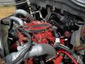 A red engine with various hoses and wiring visible designed for a 2019 International 4300 showing intricate mechanical components and connections