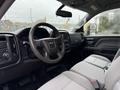 Interior view of a 2015 GMC Sierra 1500 showing the steering wheel dashboard and front seats