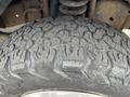 Close-up of a rugged tire tread on a vehicle showcasing deep grooves and an aggressive design suitable for off-road conditions