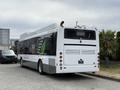 A 2018 Grande West Vicinity bus in a white and green color scheme with the back view showing taillights and branding details