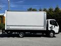 A 2018 Hino 195 truck with a white box cargo area and a black chassis parked on a paved surface