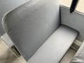 A gray upholstered seat from a 2013 International 3000 bus with a simple design and smooth texture