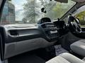 Interior view of a 2003 Mitsubishi 7 Passenger Van showcasing the dashboard and driver's seat with controls and a radio visible