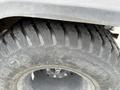 Close-up of a rugged tire from a 2011 Kubota RTV 1140 CPX featuring deep treads designed for off-road traction