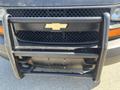 Front view of a 2012 Chevrolet Express with a black grille and a prominent Chevrolet logo in the center along with a black front bumper guard