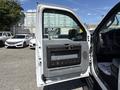 The image shows the open driver's side door of a 2012 Ford F-450 SD with a gray interior and door panel visible