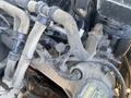 A close-up view of the engine of a 2013 Ford Expedition featuring various hoses and components with visible dirt and wear