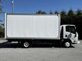 A white 2007 GMC W3500 box truck with a flatbed and no visible markings parked on a gravel surface