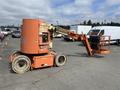A 2009 JLG E300AJP articulating boom lift with an orange body and a platform at the end of an extendable arm mounted on a wheeled base