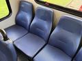 Three blue fabric seats in a vehicle interior designed for passenger comfort
