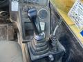 The control panel of a 2013 JCB 510-56 Loadall featuring a gear shift lever buttons and levers for operating the machine