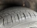 A close-up view of a tire from a 2019 Ford Transit Connect showing its tread pattern and surface wear