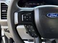 Close-up of a 2019 Ford F-550 steering wheel with control buttons including OK SET RES CNCL and a prominent blue Ford logo