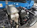Close-up of a 2020 Genie GTH-5519 engine compartment featuring a metallic cover an air filter and various engine components
