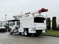 A white 2020 International MV607 truck equipped with a Terex aerial work platform mounted on the back