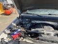 Engine compartment of a 2014 Ford F-150 with visible components such as the battery intake and hoses