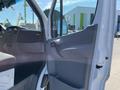 A 2010 Mercedes-Benz Sprinter van with an open driver's side door showcasing the interior layout and controls