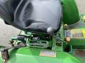 2003 John Deere 790 tractor seat with a worn black cushion gear shift lever and control levers on the operator's station