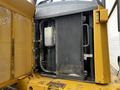 A 2006 John Deere 470G partially opened showcasing its engine compartment with visible radiator and hydraulic components
