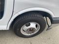 A close-up of the wheel of a 2018 Chevrolet Express showing the tire tread and lug nuts