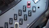 Control panel of a 2014 Freightliner Thomas Bus Diesel featuring various switches and buttons for different operations