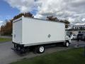 2007 GMC W5500 18 foot cube van with a white cargo box and rear loading door parked on a roadway