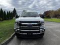 A 2020 Ford F-250 Super Duty pickup truck facing forward with a shiny chrome grille and the Ford emblem in the center