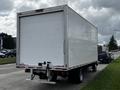 A 2019 Hino 195 delivery truck with a white box cargo area and a single rear axle parked on a street