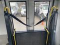 Interior view of a 2016 Chevrolet Express with a wheelchair lift featuring yellow handles and a mesh platform for accessibility