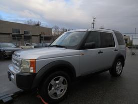 A silver 2006 Land Rover LR3 with a boxy design and distinctive front grille featuring round headlights and alloy wheels