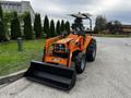 A 2001 Agco ST40 tractor with an orange body and a front loader attachment