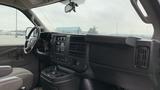 Interior view of a 2017 Chevrolet Express Quigley 4x4 featuring the dashboard steering wheel and control panel