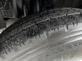 Close-up of a 2018 Isuzu NRR tire showing detailed tread pattern and surface texture with dust particles on the rubber