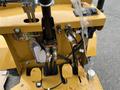 Close-up view of the control panel and hydraulic connections of a 2024 AGT Industrial KRW23 Mini Loader with various levers and wiring visible