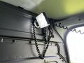 A 2017 Mercedes-Benz Sprinter interior light mounted on the wall with a coiled cord attached