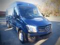 A blue 2017 Mercedes-Benz Sprinter van with a sleek design and large front grille parked at an angle showcasing its robust body and front headlights