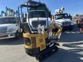 A 2024 AGT Mini Excavator with a yellow and black design featuring a bucket attachment and tracks for mobility