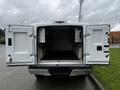 A 2017 Ford F-150 with its rear doors open revealing an empty cargo area and side storage compartments