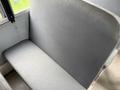 A gray vinyl bus seat from a 2013 International 3000 with simple design and no armrests