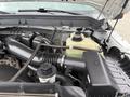 Close-up of the engine compartment of a 2015 Ford F-350 SD showing components like the air intake system and coolant reservoir