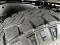 Close-up of a rugged tire with deep tread patterns designed for traction on a 2020 Ford F-350
